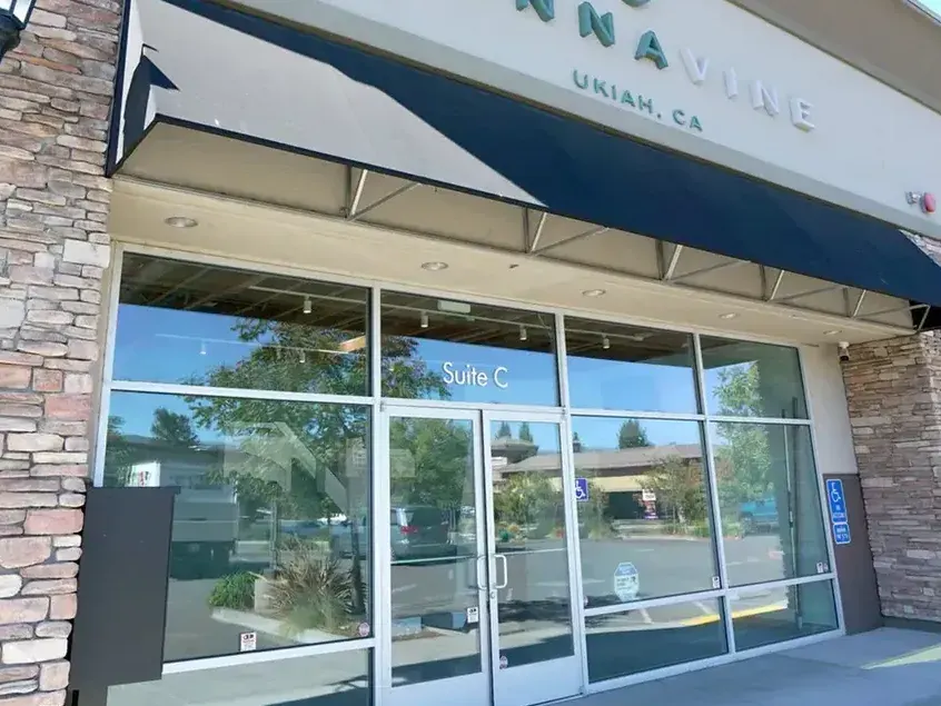 Cannavine storefront with blue awning and glass doors in Ukiah