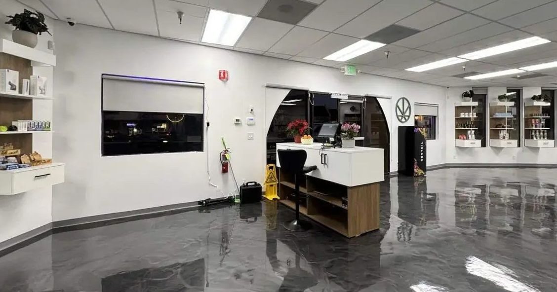 Dispensary sales floor with counter, shelves and reflective flooring